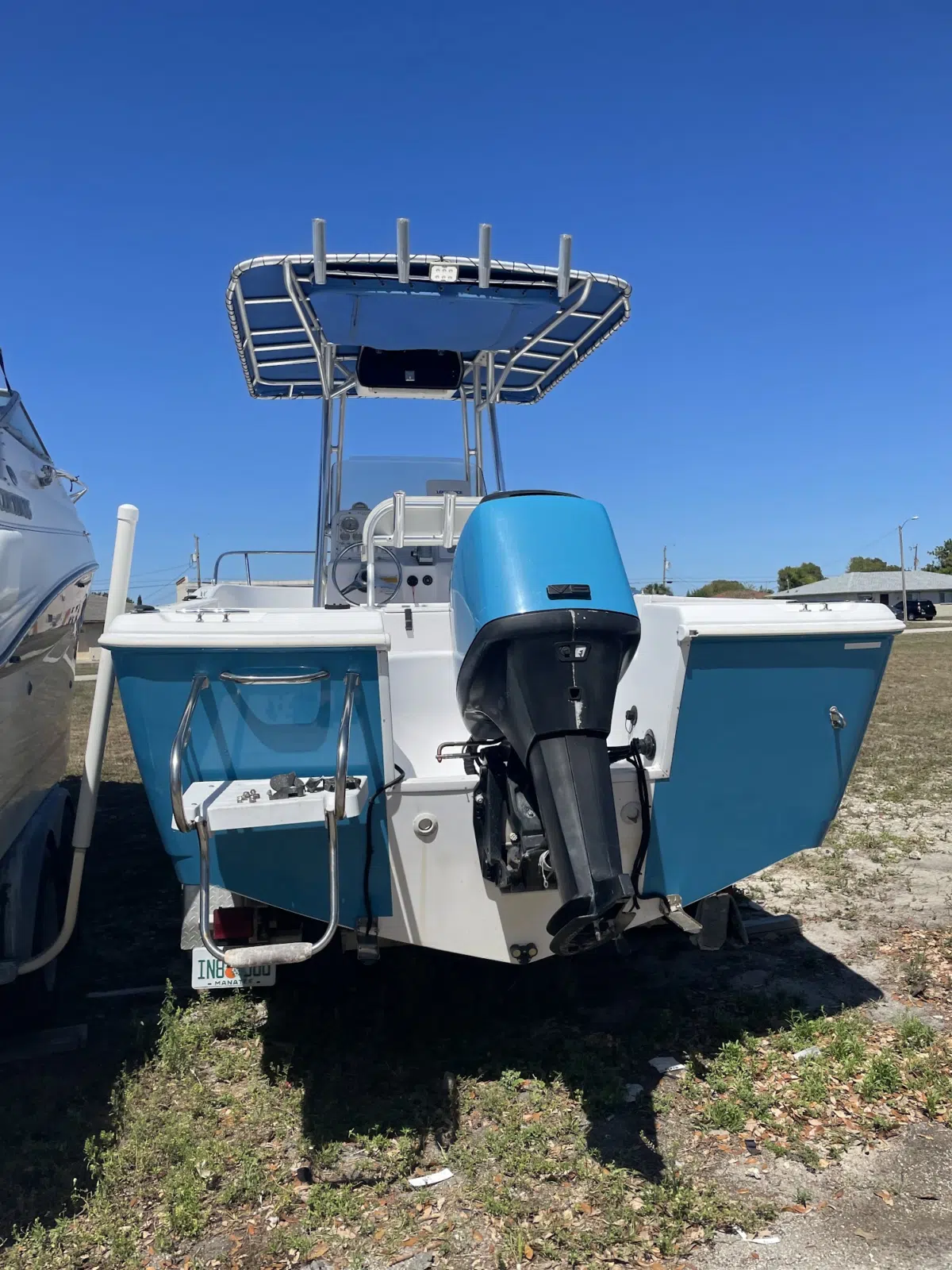Center console boat with outboard motor on a trailer — JD Marine Service in Cape Coral